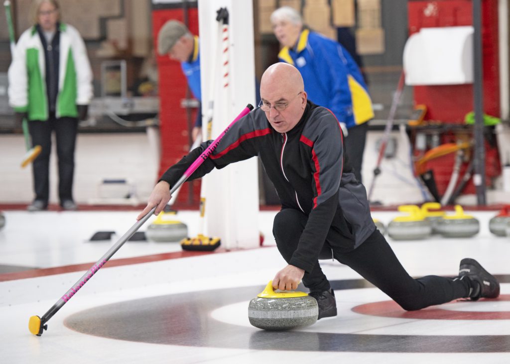 Grant Robinson throwing a rock as part of Team Ontario at CVICC 2020