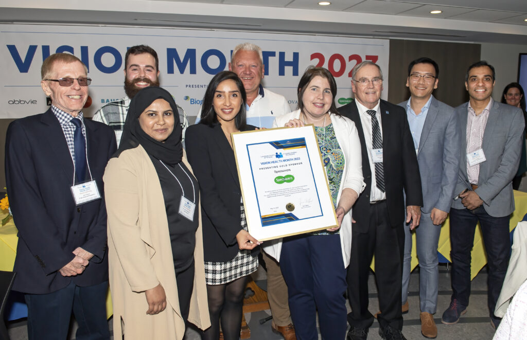Picture of Specsavers' team accepting the Gold sponsor award from the CCB National President Jim Tokos and CCB Executive Director Jim Prowse on front of the vision month 2023 banner.